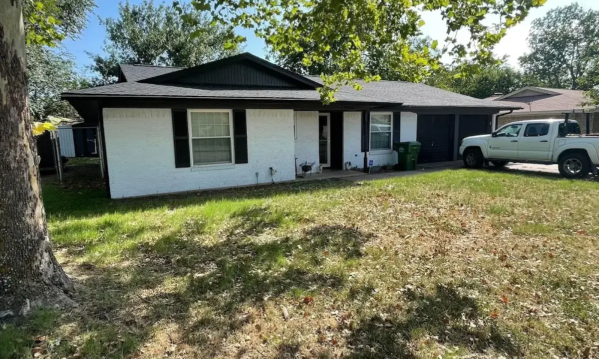 Professional roofing crew working on a residential roof in West Goshen